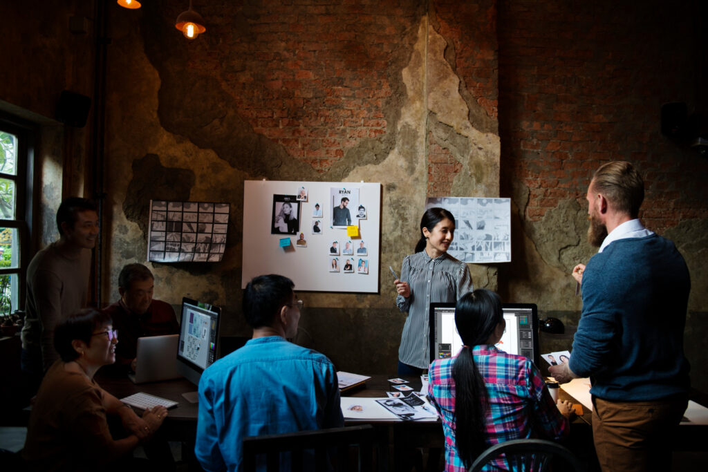 Group of creative professionals brainstorming innovative marketing ideas for a digital-era guerrilla marketing campaign