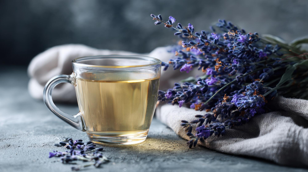 A cup of tea next to herbs